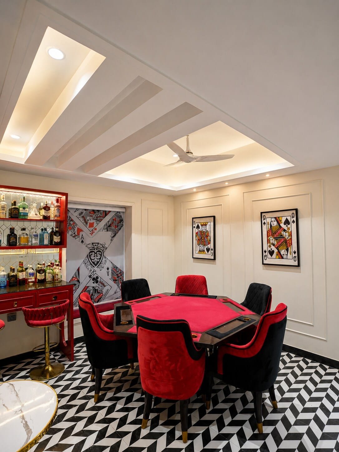 Poker table and a red-shelved bar on a black-and-white chevron floor