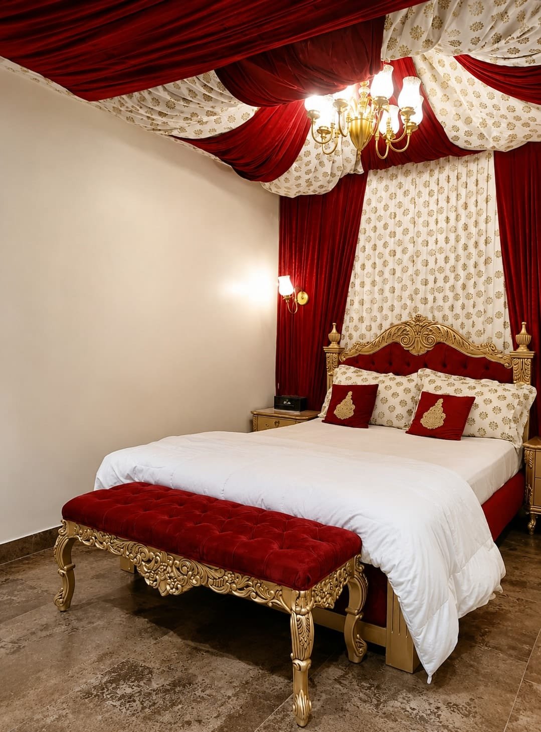 Bedroom 3 with a gilded headboard and red drapes under a chandelier