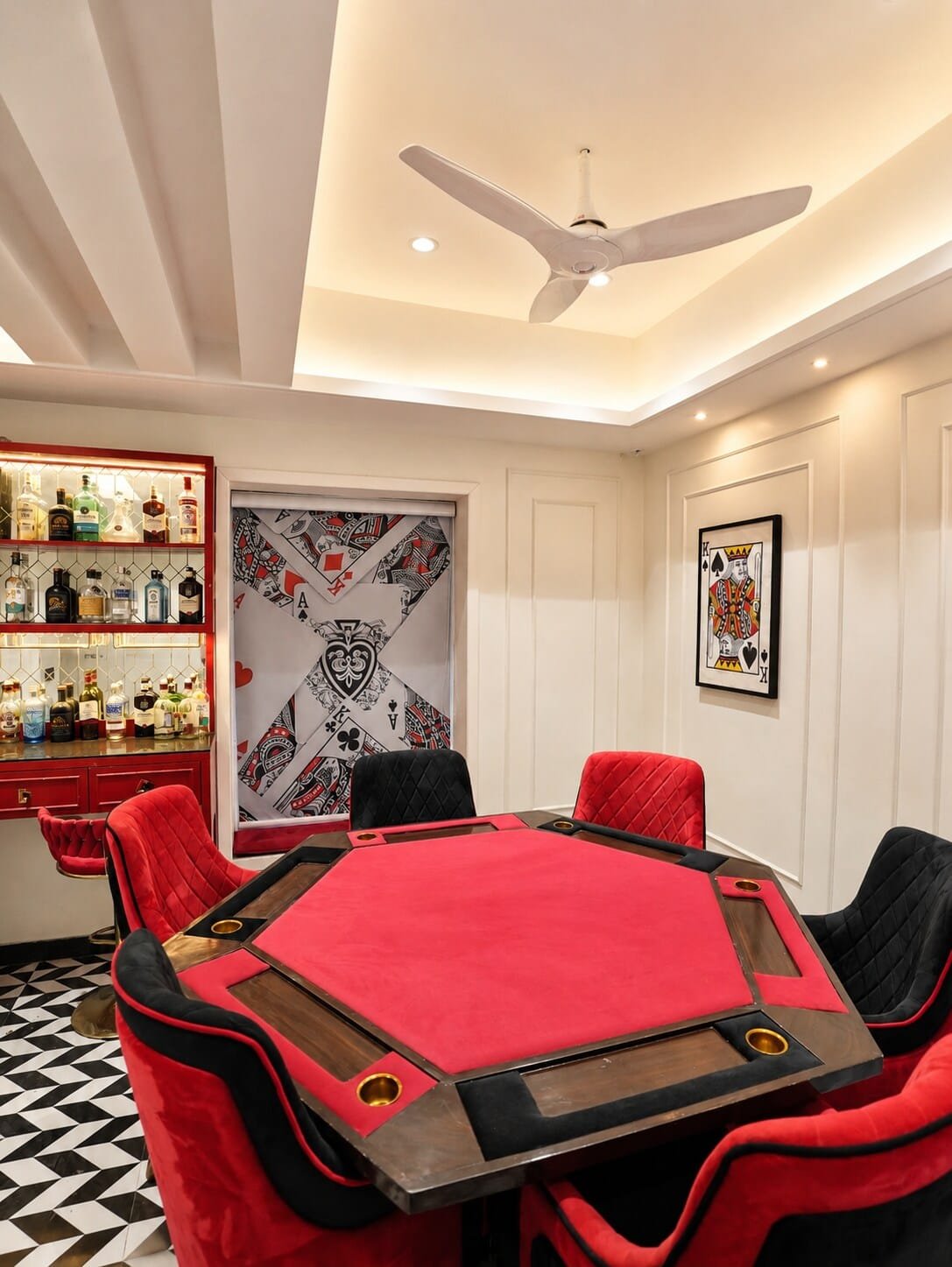 Games room with a red poker table and velvet chairs