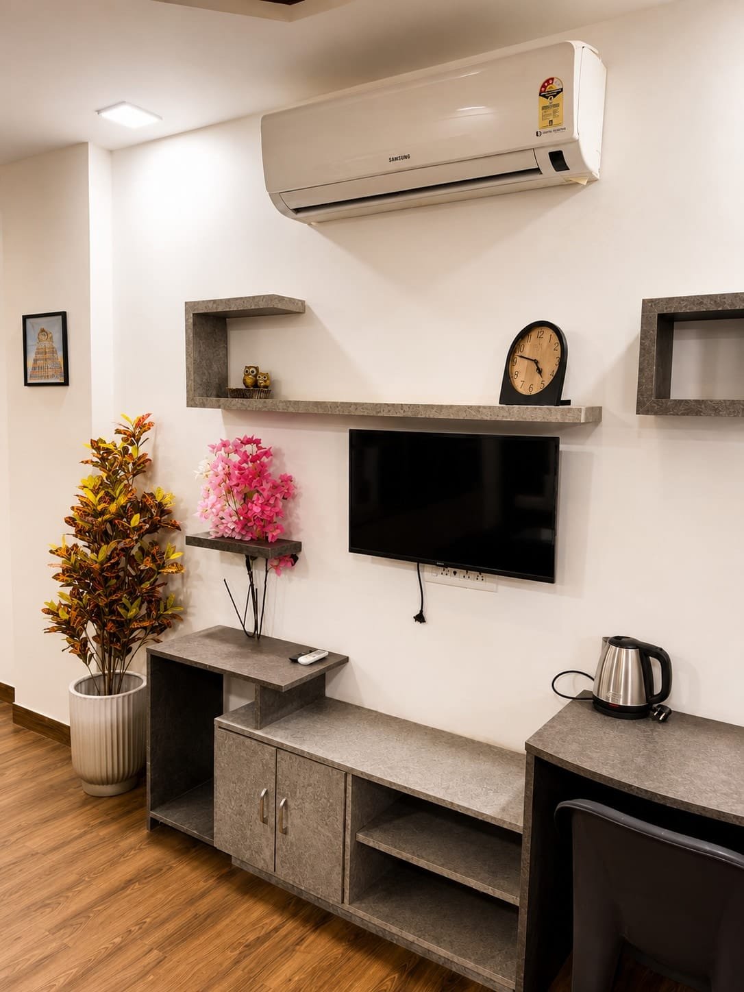 TV wall with floating shelves, a sideboard and air conditioner