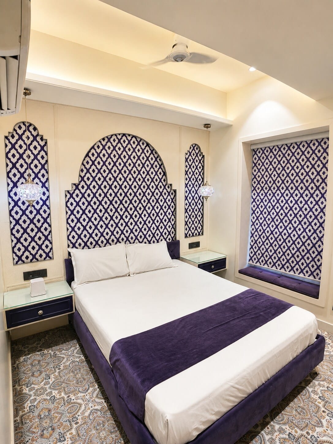 Bedroom with purple bedding and blue-and-white lattice arches