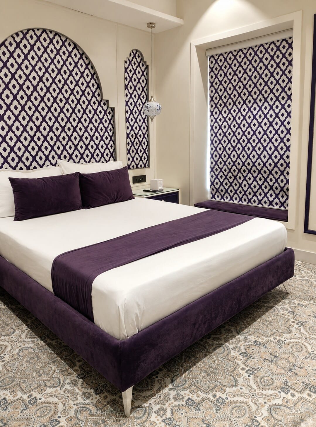 Bedroom 2 bed with a purple throw beneath lattice arches