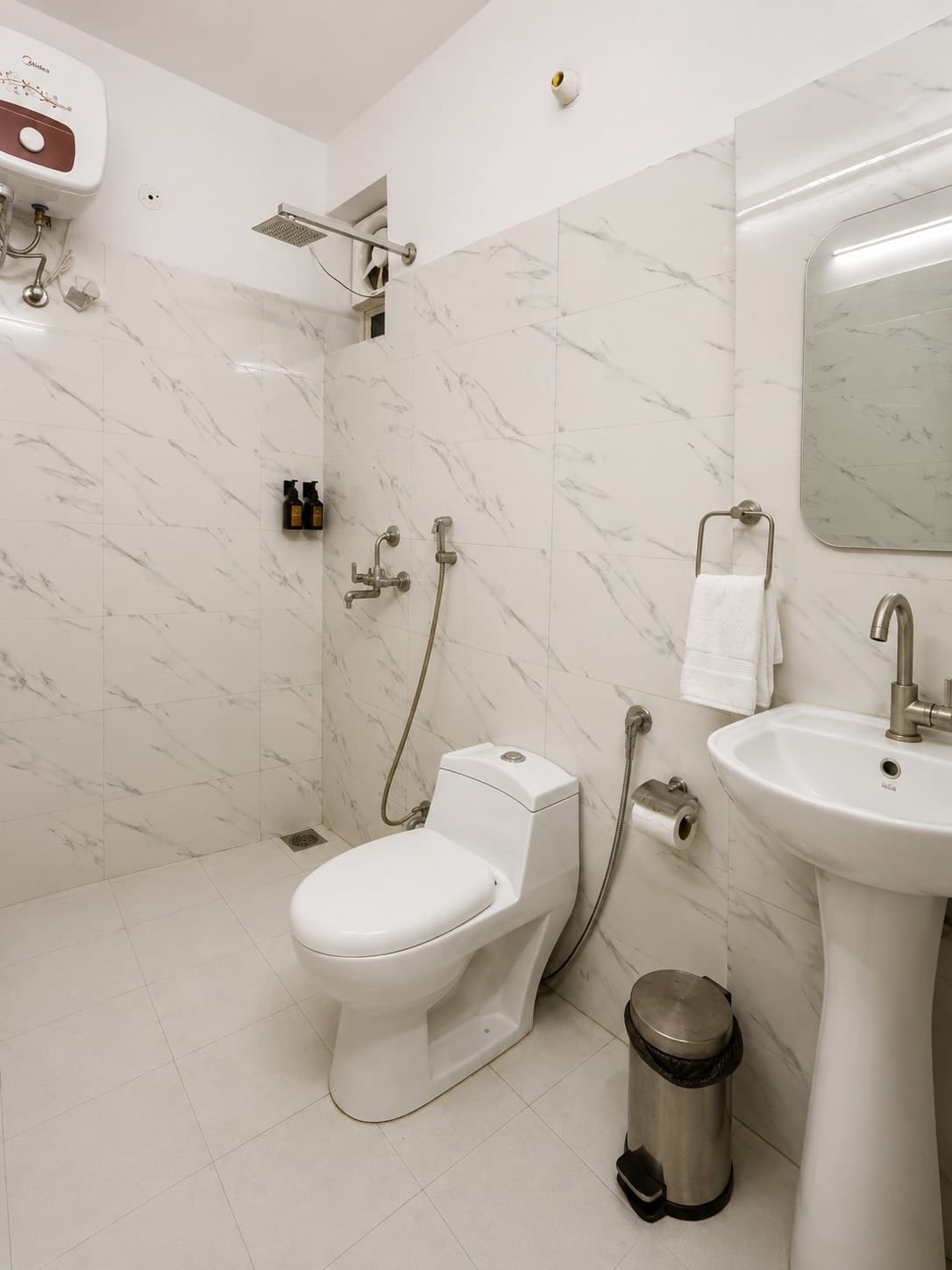 Bathroom with a walk-in shower, pedestal basin and marble-look tiles