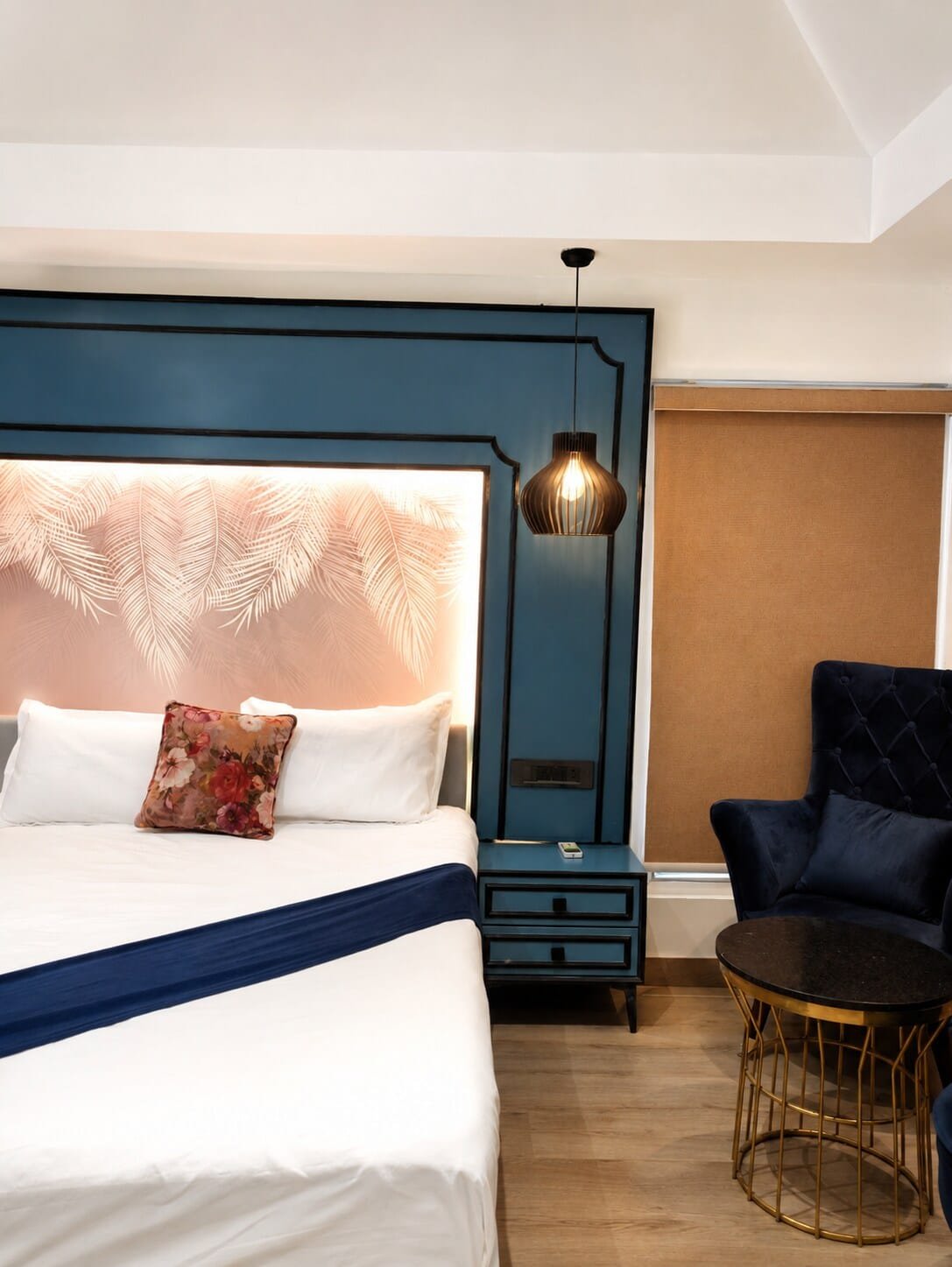 Bedroom with a navy panelled wall and a pink backlit headboard