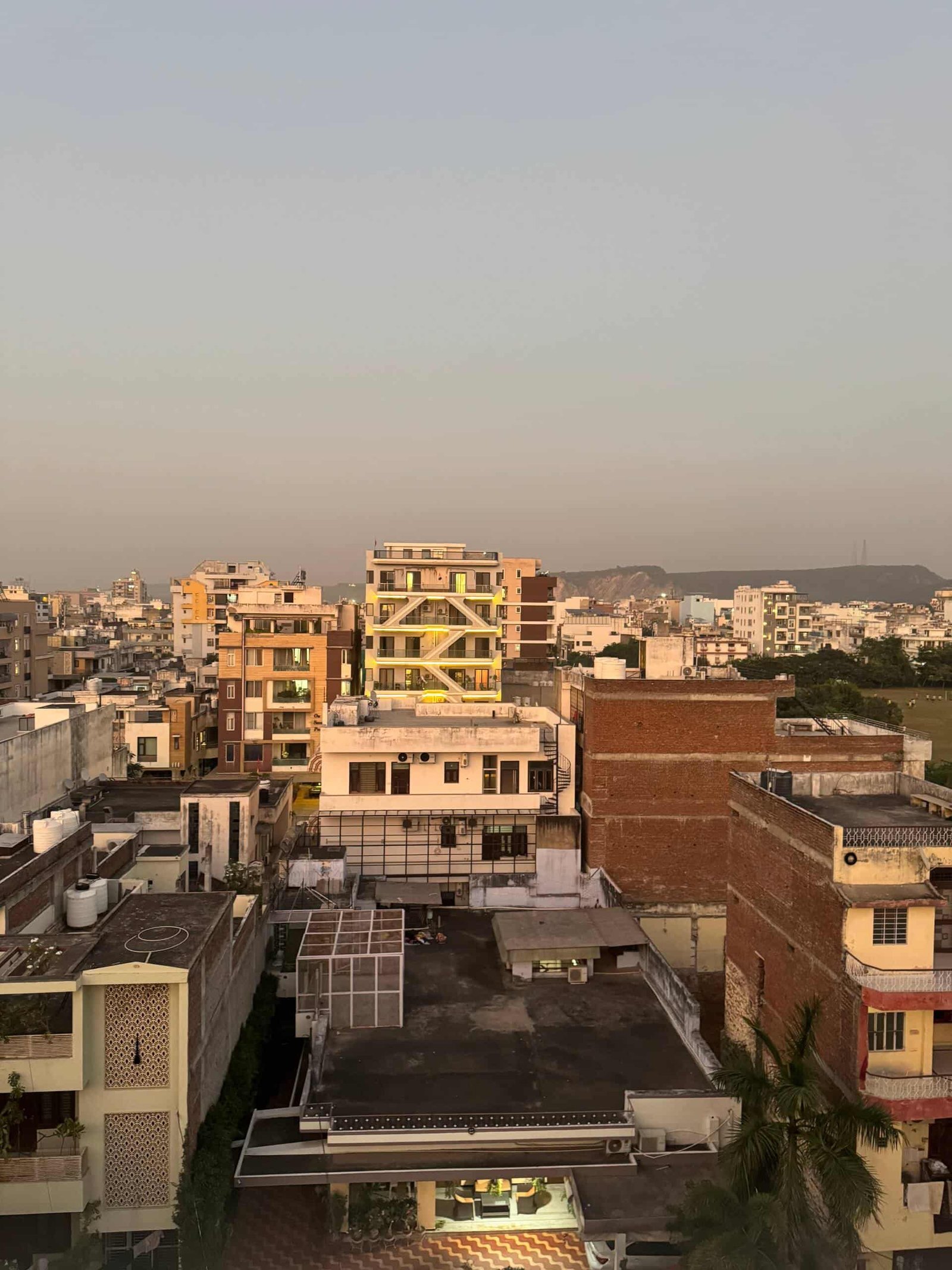 View over Jaipur rooftops at sunset from the apartment