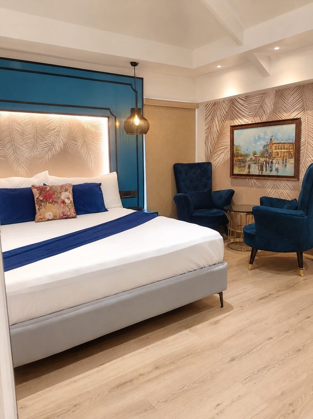 Bedroom with a navy panelled wall and a pink backlit headboard
