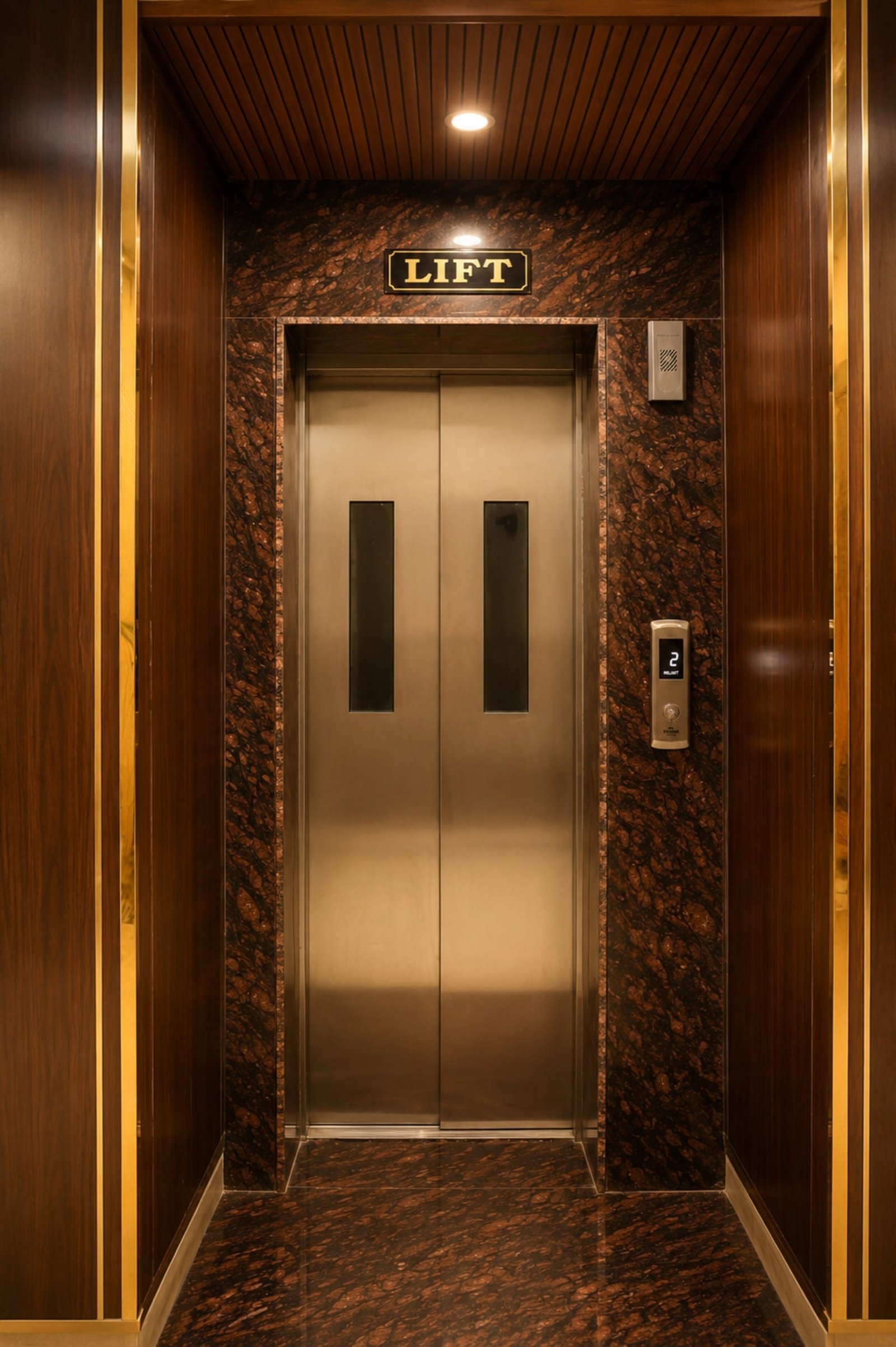 Lift doors framed in dark marble and wood