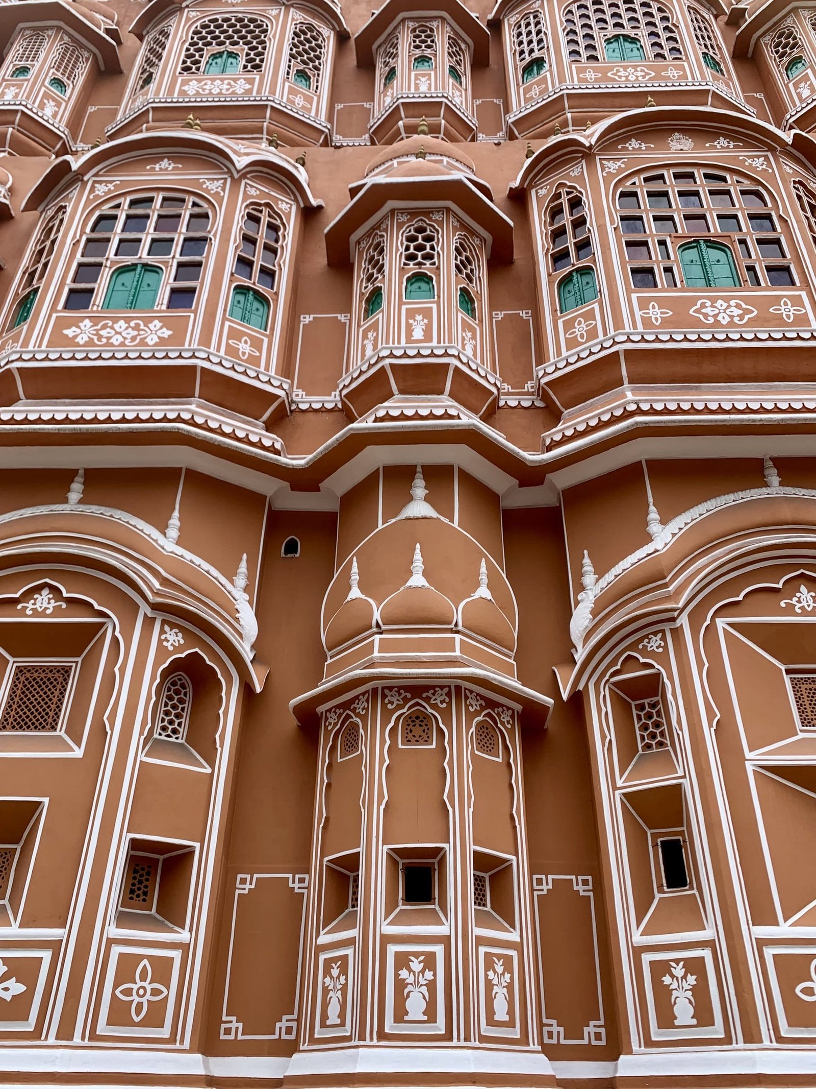 Close view of Hawa Mahal: stacked bay windows with carved stone screens